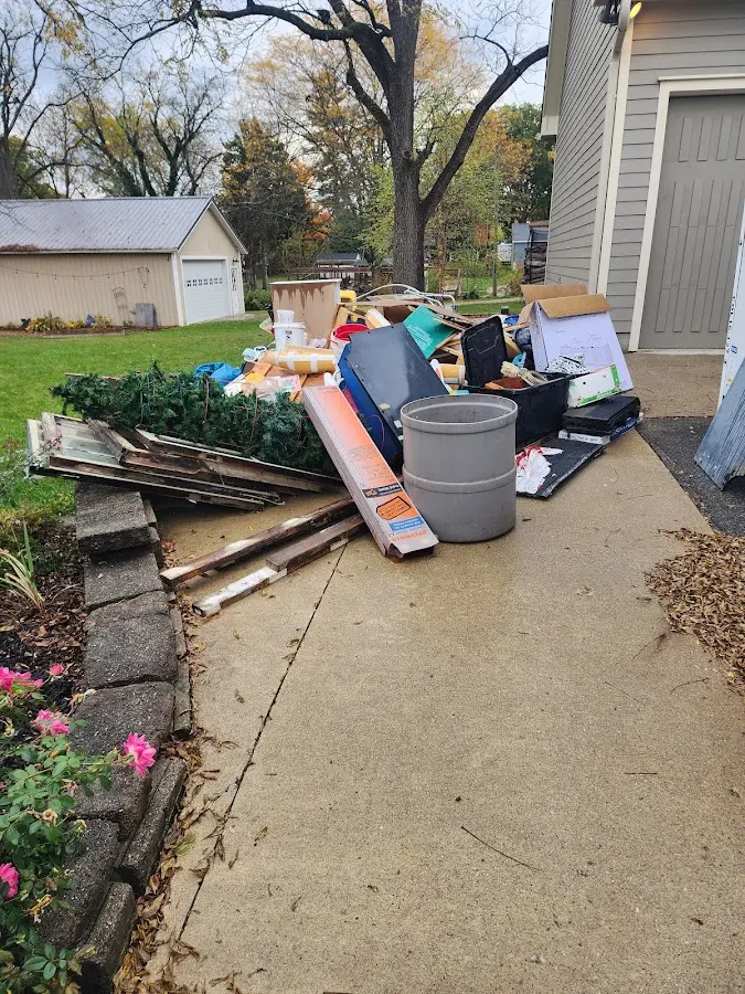 Dumpster being loaded with debris for Roofing Dumpster Rental in Sterling